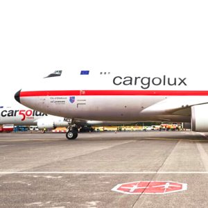 A plane with Cargolux livery sits on the tarmac of an airport runway